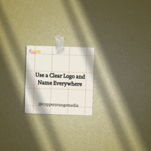 Sticky note on textured background reading “Use a Clear Logo and Name Everywhere” by @copperorangemedia, highlighting brand consistency tips.