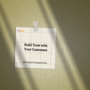 Sticky note on textured background reading “Build Trust with Your Customers” by @copperorangemedia, emphasizing relationship-based branding.