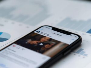 Close-up of a smartphone or tablet showing a social media marketing video,